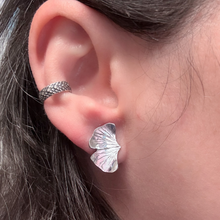 Load image into Gallery viewer, Close-up of an ear wearing a silver leaf-shaped earring.