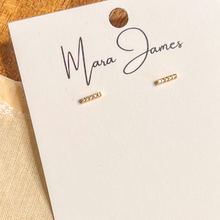 Load image into Gallery viewer, Minimal pavé gold-plated bar stud earrings on Mara James jewelry card
