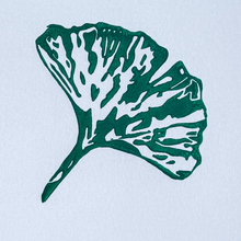 Load image into Gallery viewer, Green leaf design on a light blue background
