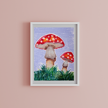 Load image into Gallery viewer, Framed artwork of two red mushrooms with white spots on a pink wall.
